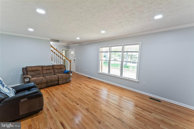 unfurnished living room featuring visible vents, stairs, baseboards, light wood finished floors, and recessed lighting