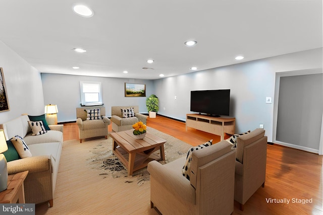 living area featuring recessed lighting, baseboards, and wood finished floors