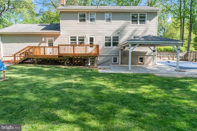 rear view of property with a chimney, a deck, a patio area, a gazebo, and fence