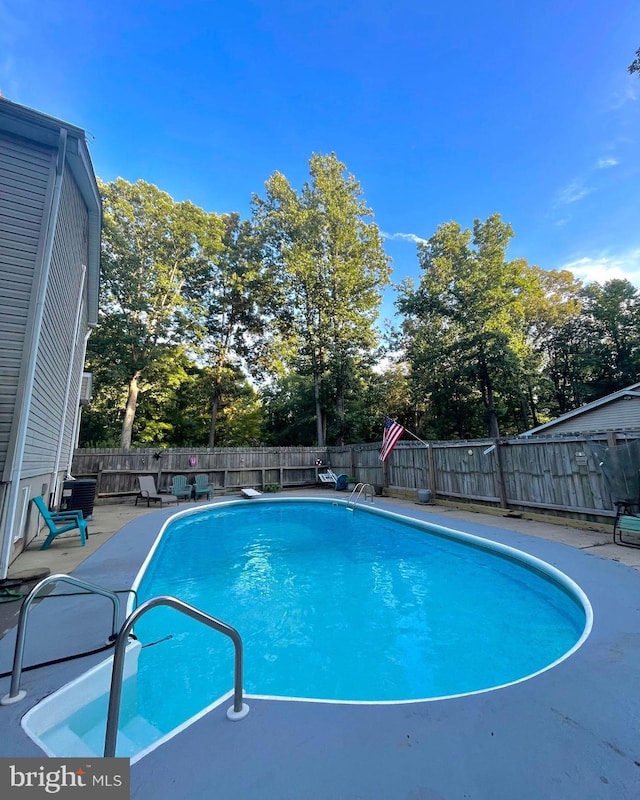 view of swimming pool with a patio, a fenced in pool, and a fenced backyard