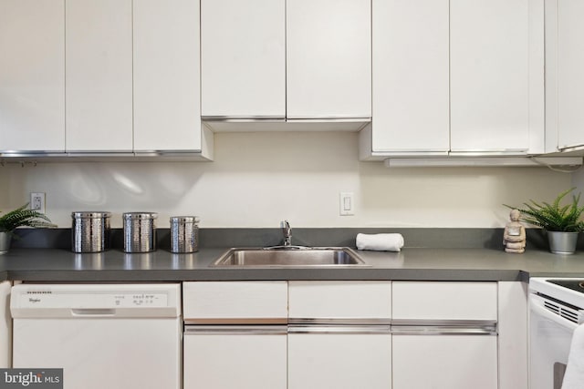 kitchen featuring white cabinets, dishwasher, a sink, and dark countertops