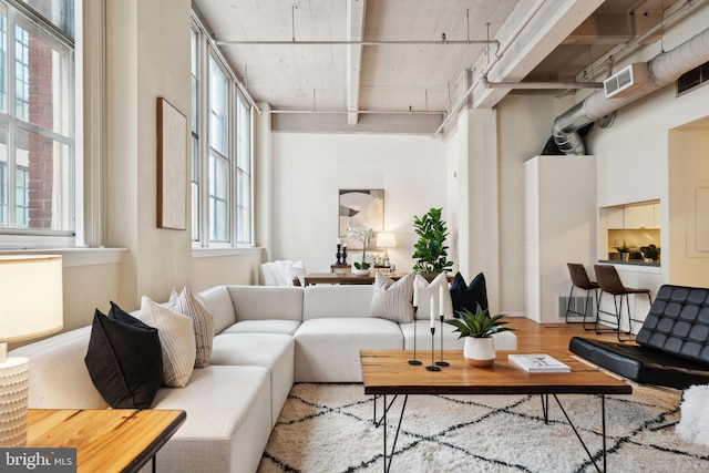 living room with visible vents and wood finished floors