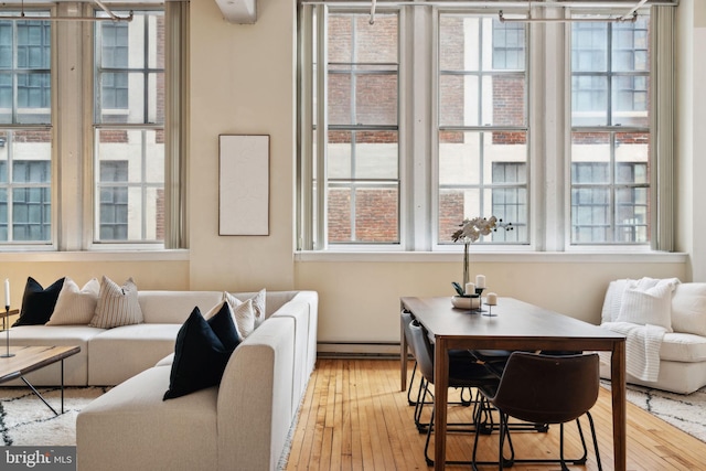 dining space featuring hardwood / wood-style floors and a baseboard radiator