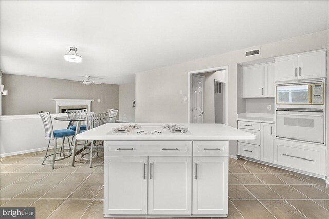 5342 Saint James Pl, Frederick, MD 21703 - kitchen featuring light tile patterned floors, ceiling fan, visible vents, light countertops, and white appliances