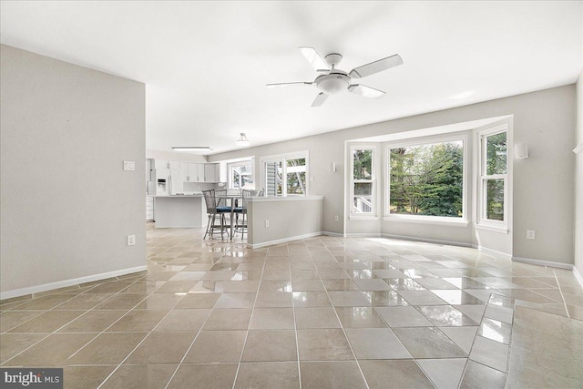 5342 Saint James Pl, Frederick, MD 21703 - unfurnished living room featuring light tile patterned flooring, ceiling fan, and baseboards