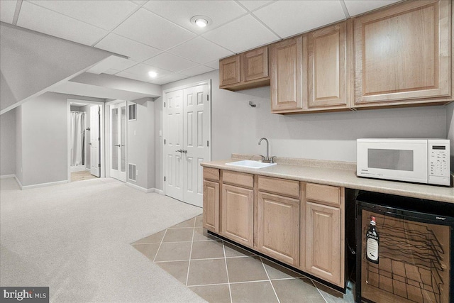 5342 Saint James Pl, Frederick, MD 21703 - kitchen featuring white microwave, light brown cabinetry, light countertops, a sink, and visible vents