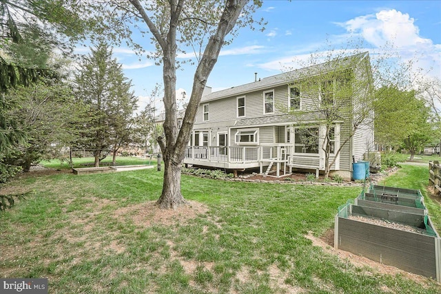 5342 Saint James Pl, Frederick, MD 21703 - rear view of house featuring a lawn, a garden, and a wooden deck