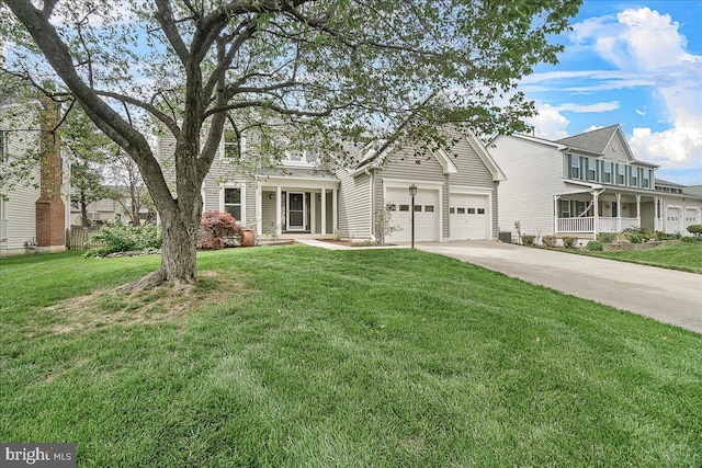 5342 Saint James Pl, Frederick, MD 21703 - view of front of house with concrete driveway, fence, a front lawn, and a garage