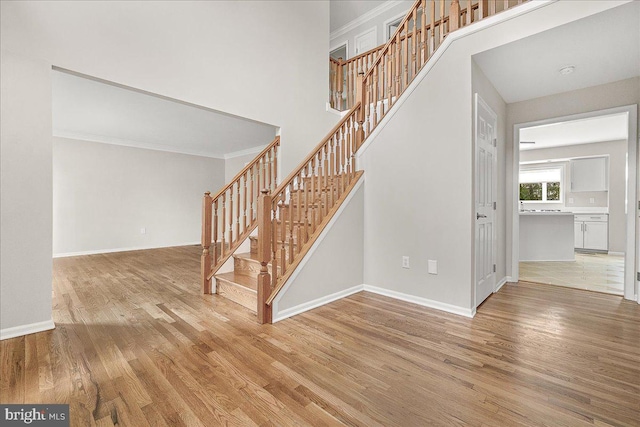 5342 Saint James Pl, Frederick, MD 21703 - stairway with ornamental molding, wood finished floors, and baseboards