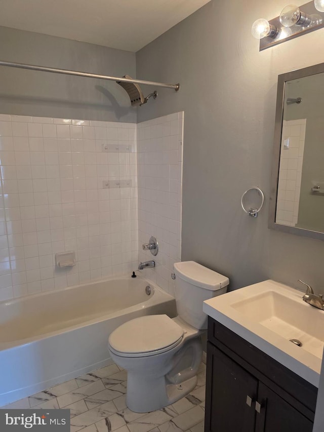 bathroom featuring toilet, vanity, and bathing tub / shower combination