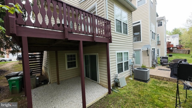 rear view of property with cooling unit, a yard, a patio, and a deck