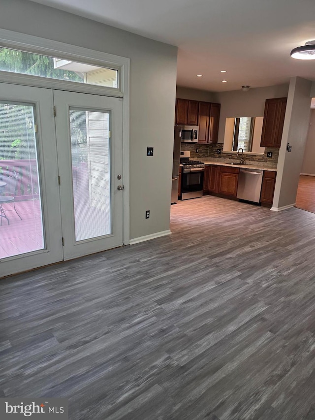 interior space featuring recessed lighting, baseboards, and dark wood-style floors