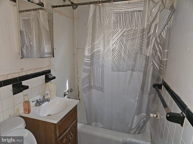 bathroom with vanity, toilet, tile walls, backsplash, and shower / bath combination with curtain