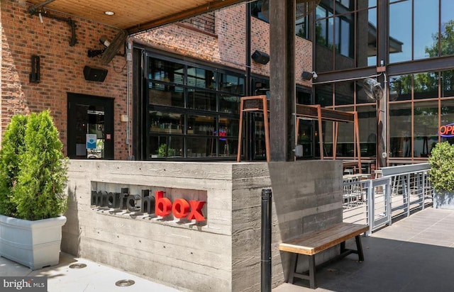 property entrance featuring brick siding