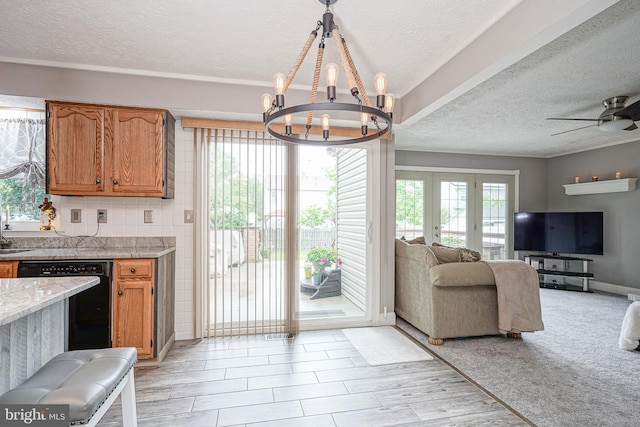 619 Walden Way, Lumberton, NJ 08048 - kitchen featuring black dishwasher, open floor plan, a textured ceiling, a chandelier, and brown cabinetry
