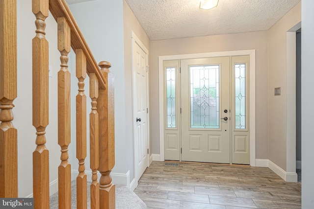 619 Walden Way, Lumberton, NJ 08048 - foyer featuring light wood-style floors, a textured ceiling, stairs, and baseboards