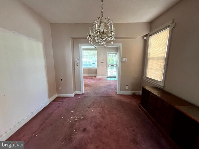 721 Tuckerman St NW, Washington, DC 20011 - unfurnished dining area with baseboards, a notable chandelier, and carpet floors