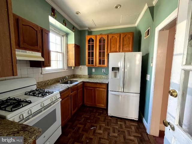 721 Tuckerman St NW, Washington, DC 20011 - kitchen with white appliances, glass insert cabinets, under cabinet range hood, ornamental molding, and a sink