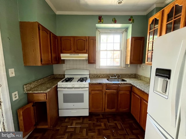 721 Tuckerman St NW, Washington, DC 20011 - kitchen with a sink, under cabinet range hood, ornamental molding, white appliances, and brown cabinetry
