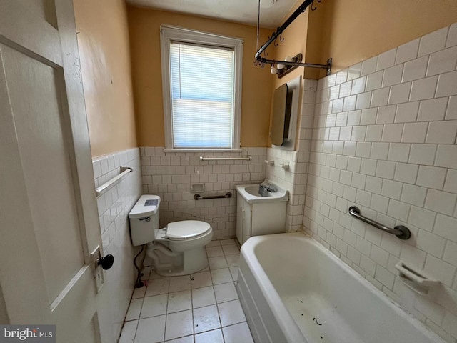 721 Tuckerman St NW, Washington, DC 20011 - bathroom with tile walls, a bath, toilet, tile patterned flooring, and wainscoting