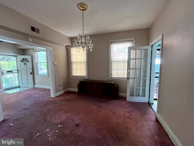 721 Tuckerman St NW, Washington, DC 20011 - unfurnished dining area featuring visible vents, baseboards, a chandelier, and carpet floors