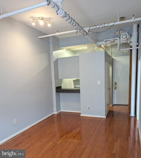 empty room featuring baseboards and wood finished floors