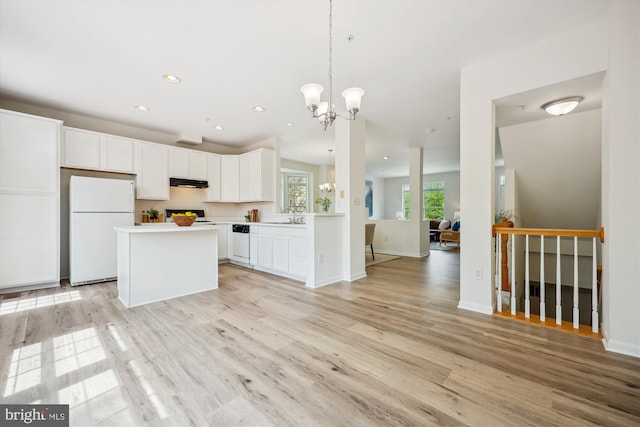 13416 Ansel Ter, Germantown, MD 20874 - kitchen with a kitchen island, white cabinets, a chandelier, under cabinet range hood, and white appliances