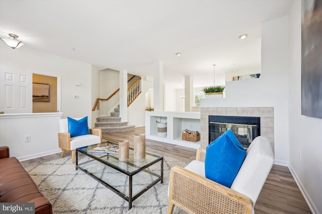 13416 Ansel Ter, Germantown, MD 20874 - living area with baseboards, a fireplace, wood finished floors, and stairway