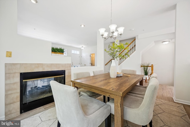 13416 Ansel Ter, Germantown, MD 20874 - dining space featuring recessed lighting, an inviting chandelier, a tiled fireplace, and stairway