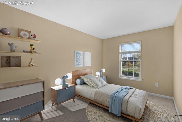 bedroom with carpet flooring and baseboards