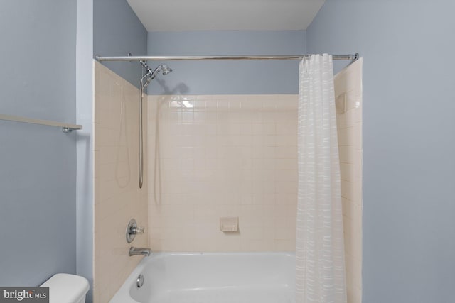 bathroom featuring toilet and shower / bathtub combination with curtain