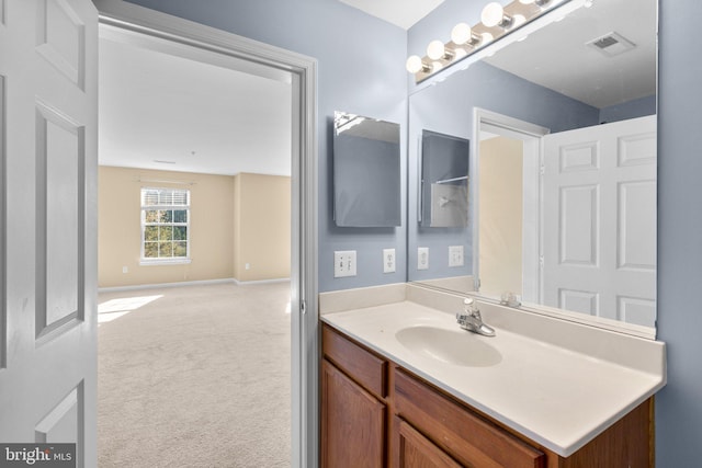 bathroom featuring vanity, baseboards, and visible vents