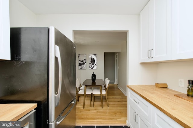 4803 30th St S Unit A2, Arlington, VA 22206 - kitchen with butcher block counters, freestanding refrigerator, white cabinets, and light wood-type flooring