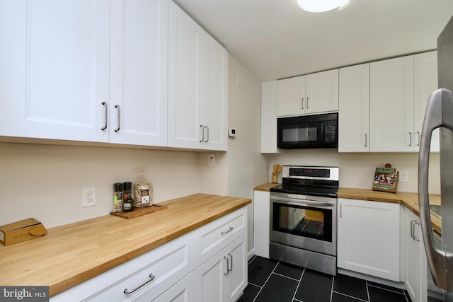 4803 30th St S Unit A2, Arlington, VA 22206 - kitchen featuring appliances with stainless steel finishes, butcher block countertops, dark tile patterned floors, and white cabinetry