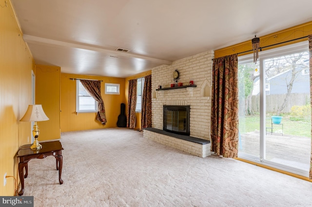 unfurnished living room with visible vents, carpet flooring, and a fireplace