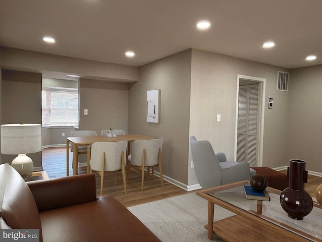 living room featuring baseboards, wood finished floors, visible vents, and recessed lighting