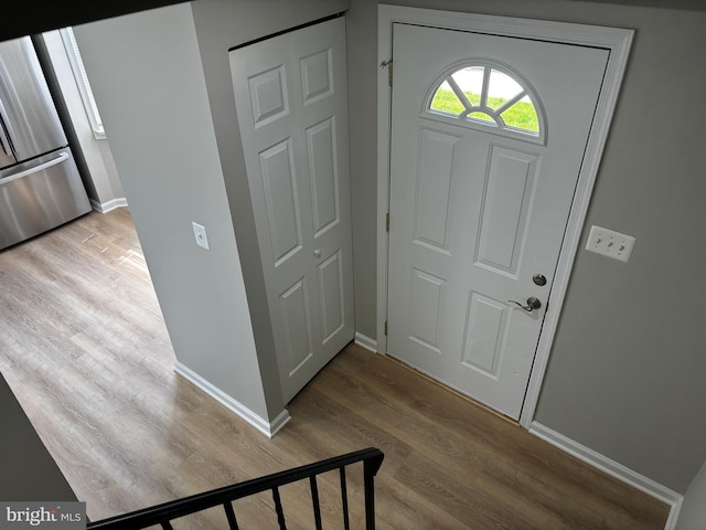 entryway with baseboards and wood finished floors