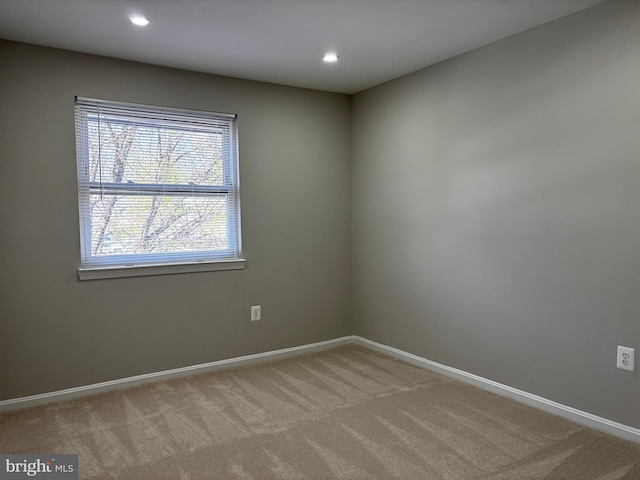 spare room featuring recessed lighting, baseboards, and carpet