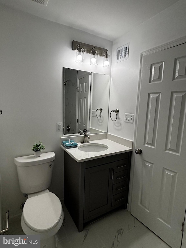 bathroom featuring marble finish floor, toilet, vanity, and visible vents