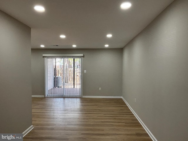 unfurnished room with baseboards, recessed lighting, and dark wood finished floors