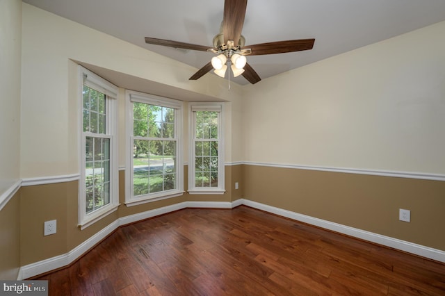 spare room with wood-type flooring, baseboards, and ceiling fan