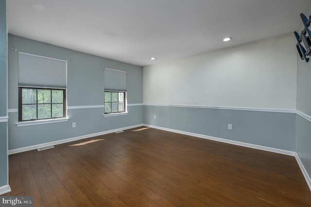 spare room featuring baseboards, wood-type flooring, recessed lighting, and visible vents