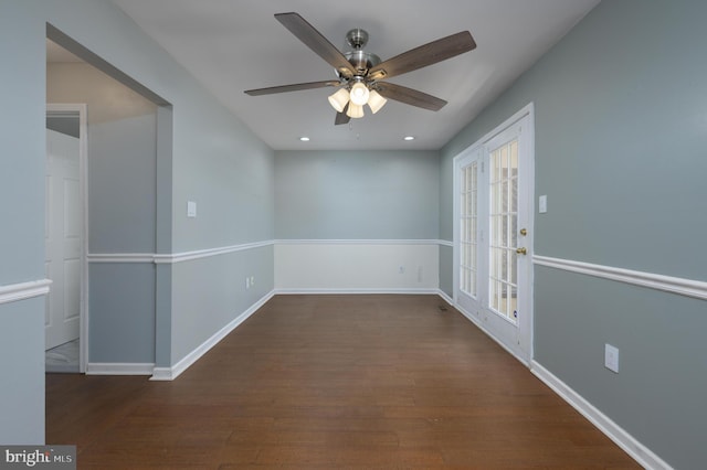 empty room featuring baseboards, a ceiling fan, and wood finished floors