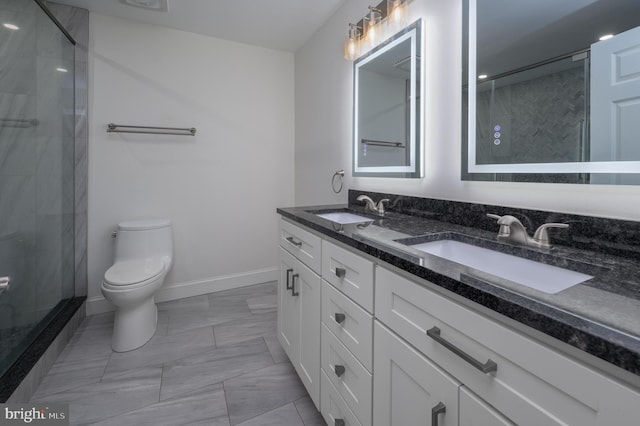 bathroom with toilet, a sink, marble finish floor, and a stall shower