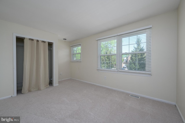 unfurnished bedroom with visible vents, baseboards, and carpet floors