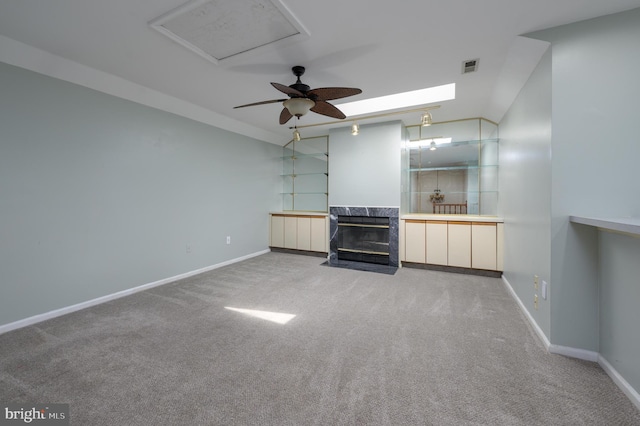 unfurnished living room with a high end fireplace, baseboards, and carpet flooring