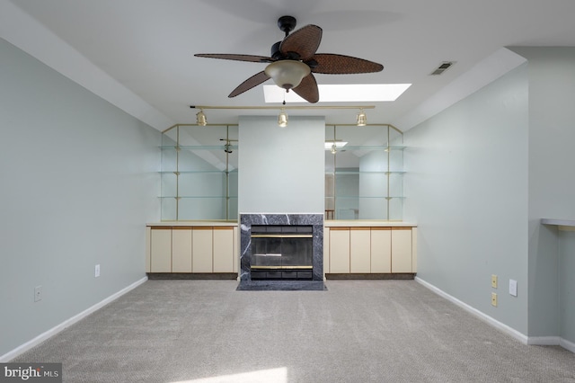 unfurnished living room featuring carpet flooring, a ceiling fan, baseboards, and visible vents