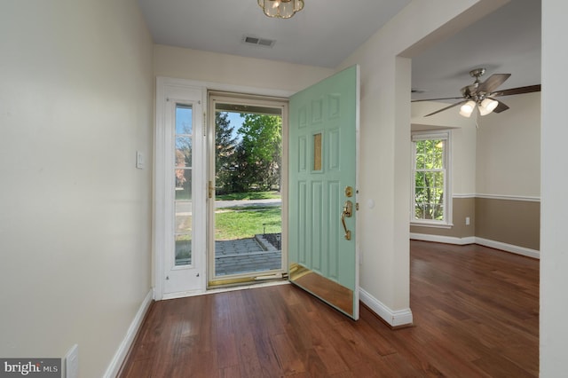 entryway featuring visible vents, baseboards, and wood finished floors