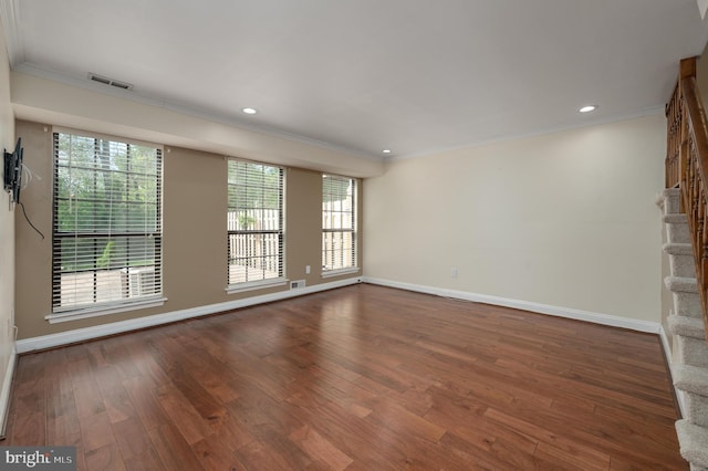 unfurnished living room with crown molding, baseboards, visible vents, and hardwood / wood-style floors