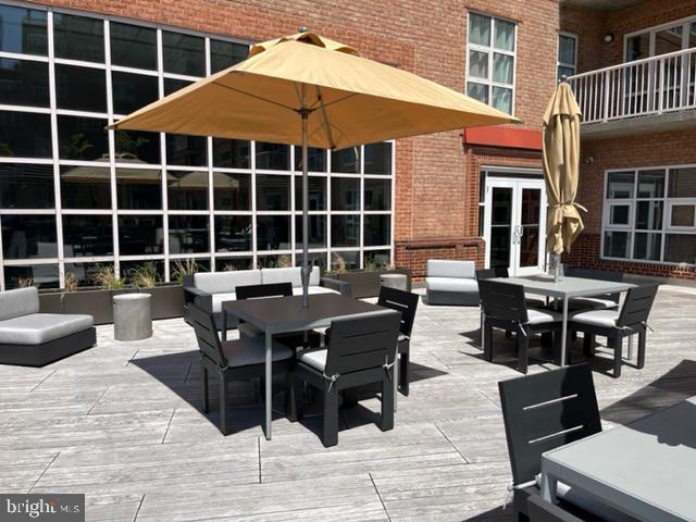 250 President St Unit 1001, Baltimore, MD 21202 - view of patio featuring a deck, outdoor dining space, and french doors